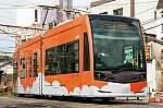 オレンジ色の雲塗装の堺トラム(ウソ電)