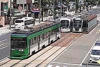 vehicle, land vehicle, tram, outdoor, transport, green, streetcar, bus, city, train, busy, traveling, railroad, several